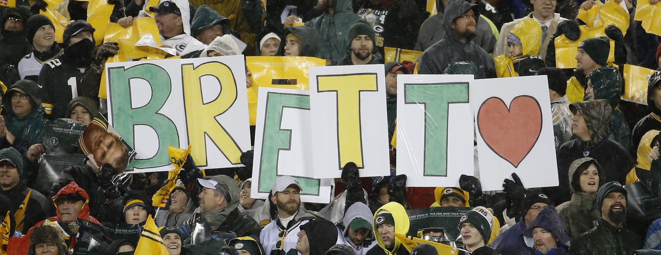 Fans hold up a sign for Brett Favre during a ceremony at halftime of an NFL football game between the Green Bay Packers and Chicago Bears Thursday, Nov. 26, 2015, in Green Bay, Wis. Favre’s retired No. 4 and name were unveiled inside Lambeau Field during the ceremony. (AP Photo/Morry Gash)
