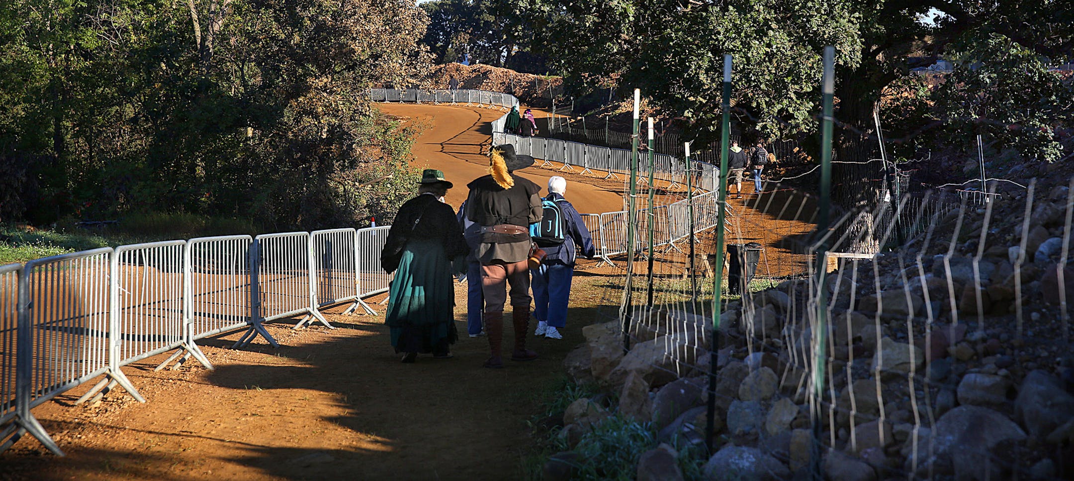 Patrons walk along a path that circumvents a large mining site, as they head toward the Renaissance Festival grounds. ] JIM GEHRZ ‚Ä¢ jgehrz@startribune.com / Shakopee, MN / Sept. 13, 2014 / 8:30 AM / BACKGROUND INFORMATION: For decades the Renaissance Festival has been trying to maintain an illusion of a return to a distant medieval past. But recent patrons report that the illusion is under strain, as a very modern-day enterprise, sand mining for oil fracking, is visibly gnawin