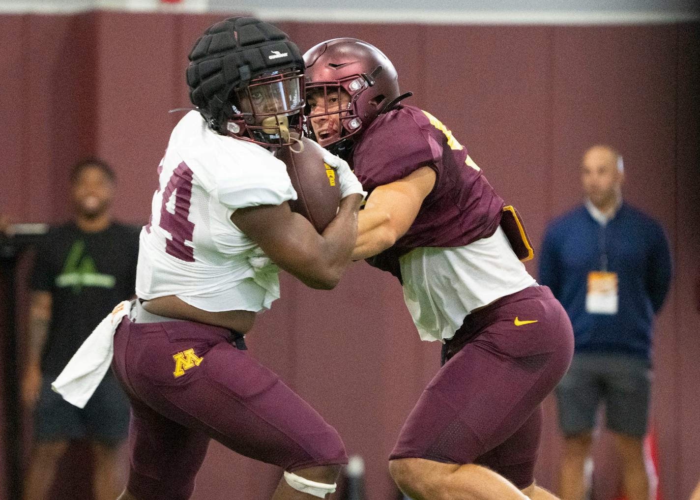 Gophers running back Mohamed Ibrahim (24) bounced off linebacker Mariano Sori-Marin during the football team's open practice Saturday at Athletes Village.