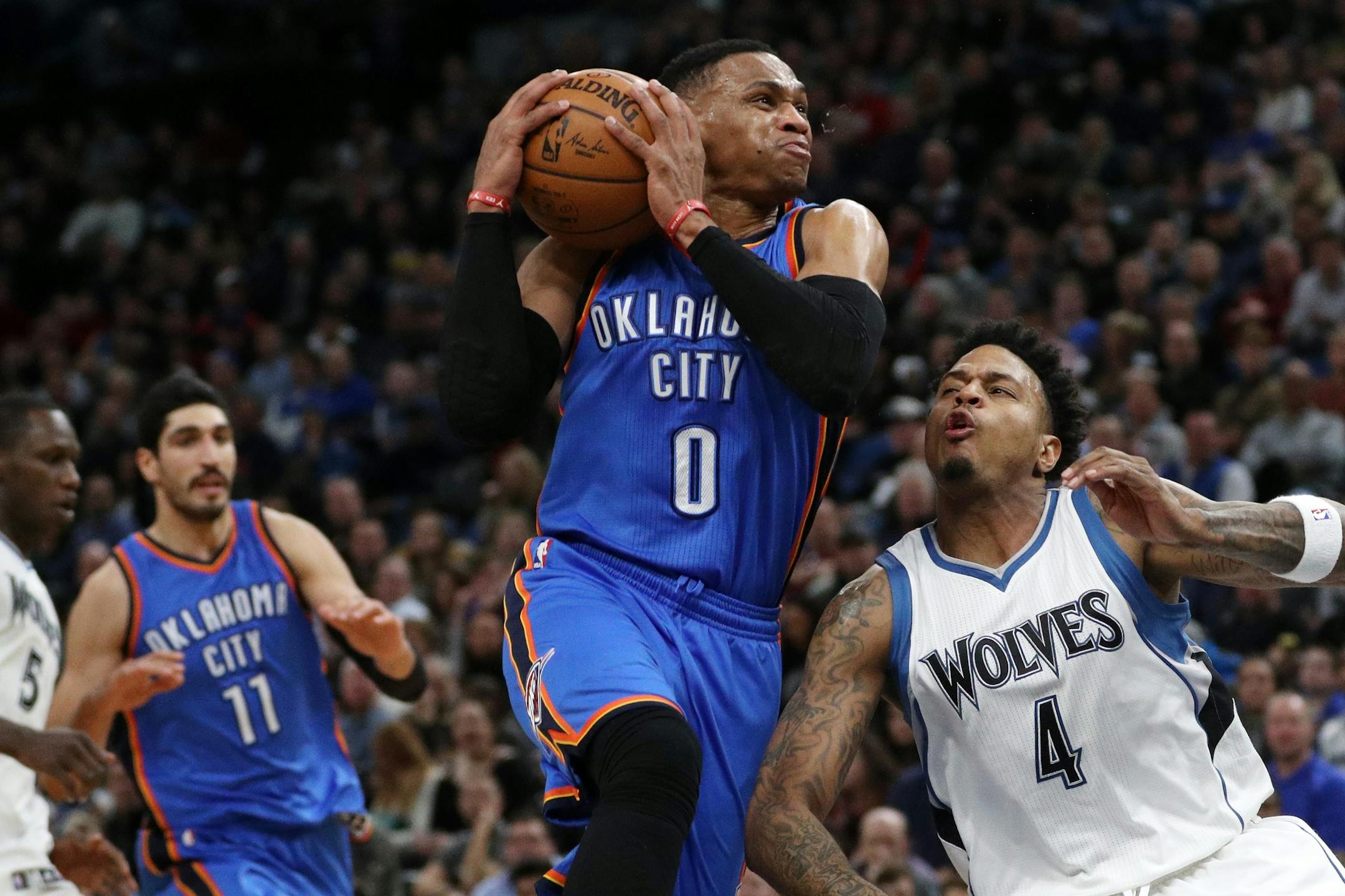 Oklahoma City Thunder guard Russell Westbrook (0) drives to the basket around Minnesota Timberwolves guard Brandon Rush (4) during the second half.