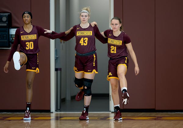 Gophers women's basketball players from left, Kadi Sissoko, Grace Cumming, and Caroline Strande, warmed up during practice, Tuesday, September 28, 202