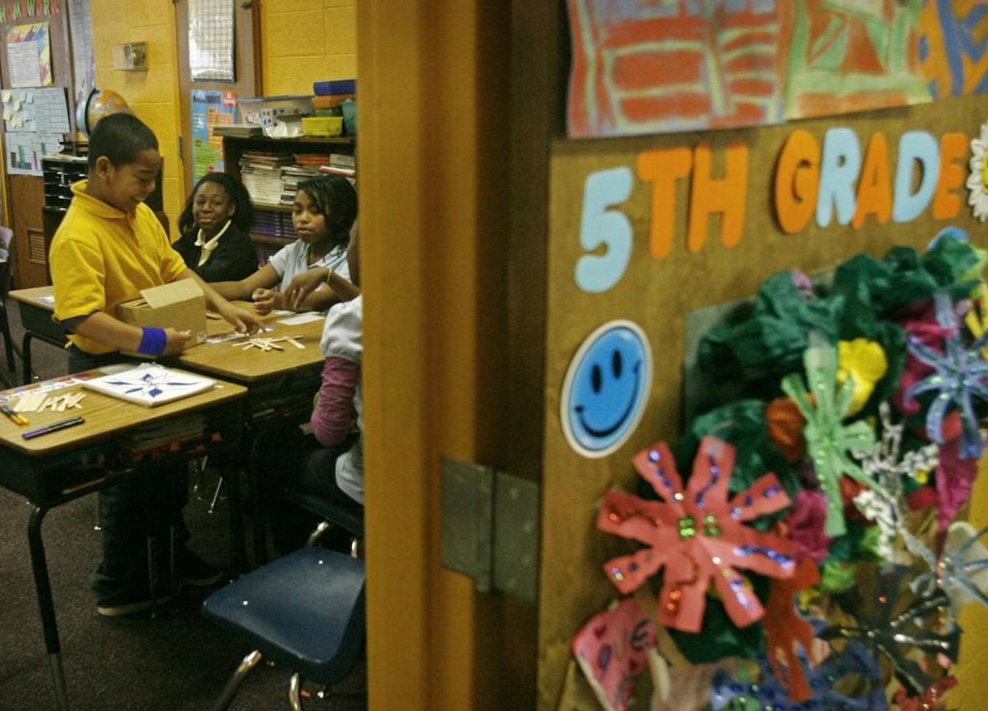 As Minneapolis paves the way for charter schools, stringent standards will follow. Students celebrated the school's holiday "Winter Wonderland" program at Friendship Academy of Fine Arts -- the only current Minneapolis Schools-authorized charter. Fifth grader Elijah Lieng, left, passed out art supplies to classmates in Sarah Pahl's class.