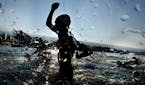 A male competitor exits the water during the swimming portion of the Ironman World Championship Triathlon, Saturday, Oct. 10, 2015, in Kailua-Kona, Ha