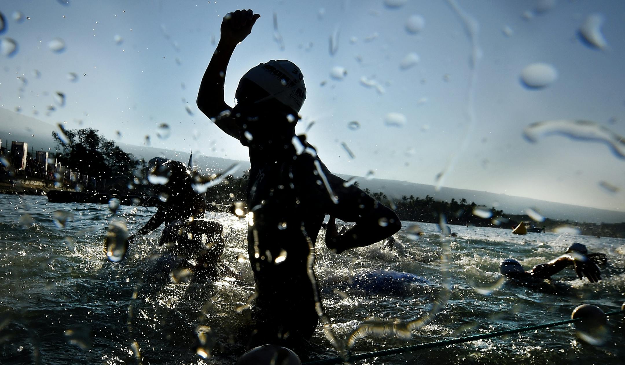 A male competitor exits the water during the swimming portion of the Ironman World Championship Triathlon, Saturday, Oct. 10, 2015, in Kailua-Kona, Hawaii. (AP Photo/Mark J. Terrill)