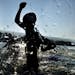 A male competitor exits the water during the swimming portion of the Ironman World Championship Triathlon, Saturday, Oct. 10, 2015, in Kailua-Kona, Ha