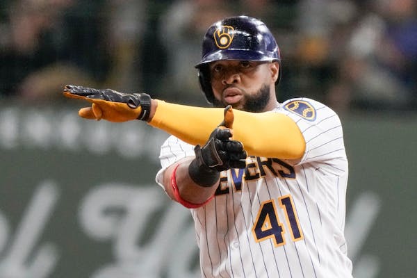 Carlos Santana, shown with the Brewers in August, celebrated after hitting an RBI double against the Padres. The Twins hope his veteran bat will help 