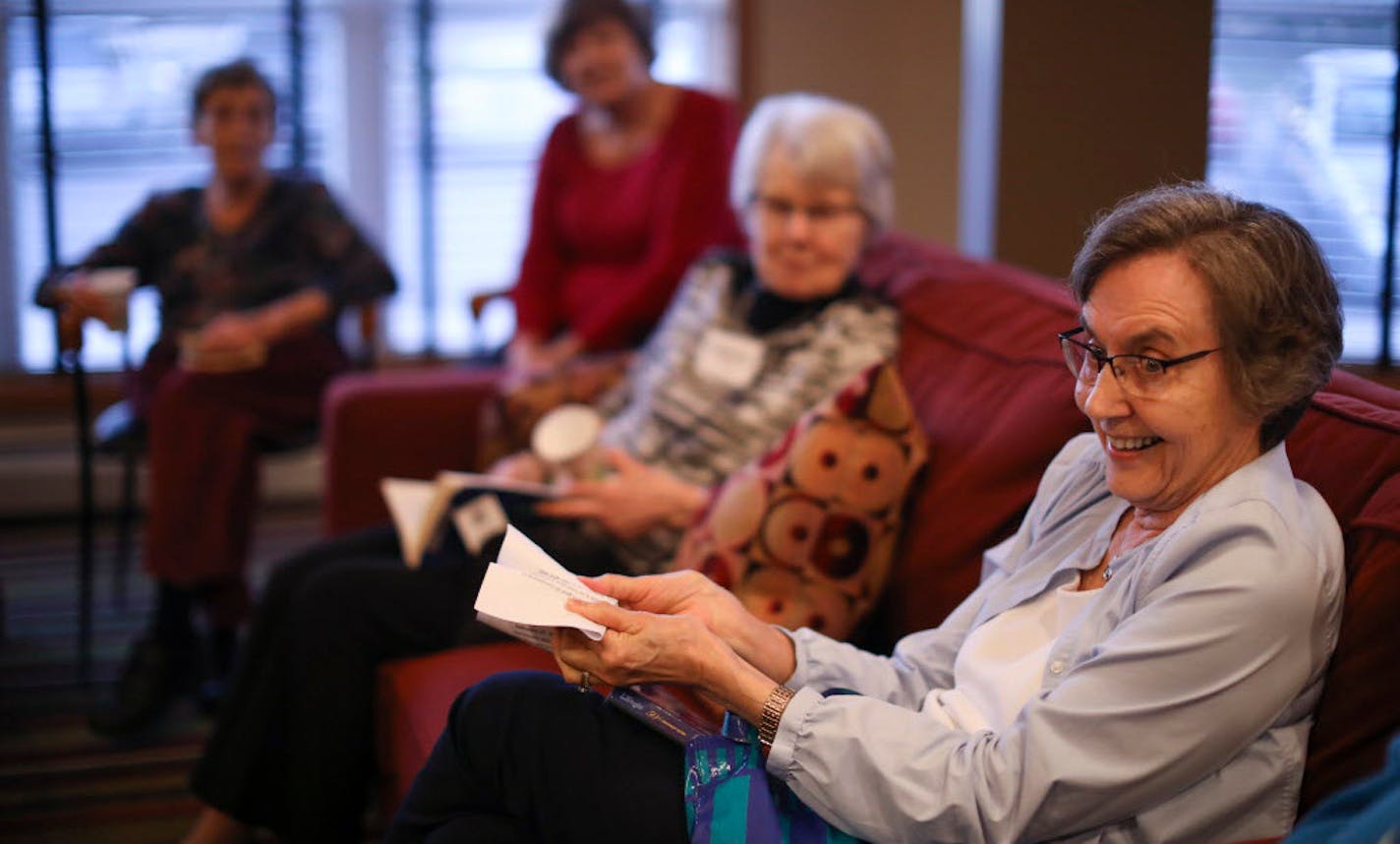 Ruth Fingerson demonstrated a time-travel concept with a piece of paper during discussion of "A Wrinkle in Time" at Summit Place in Eden Prairie.