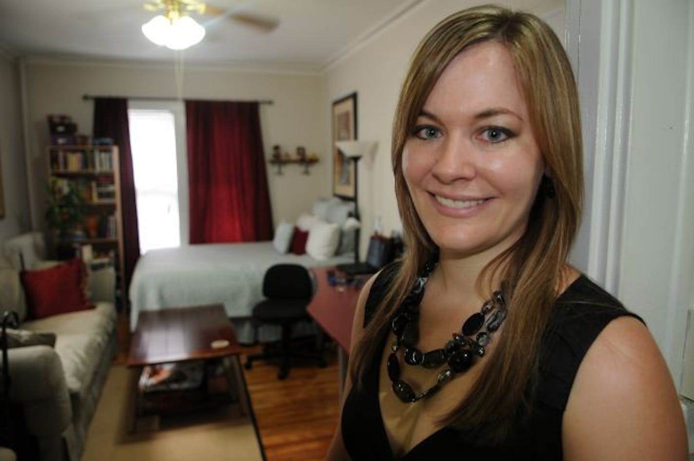 Minneapolis Mn. Wednesday 7/7/10 Courtney Zinter in her downsized apartment, where her living room is also her bedroom and home office.