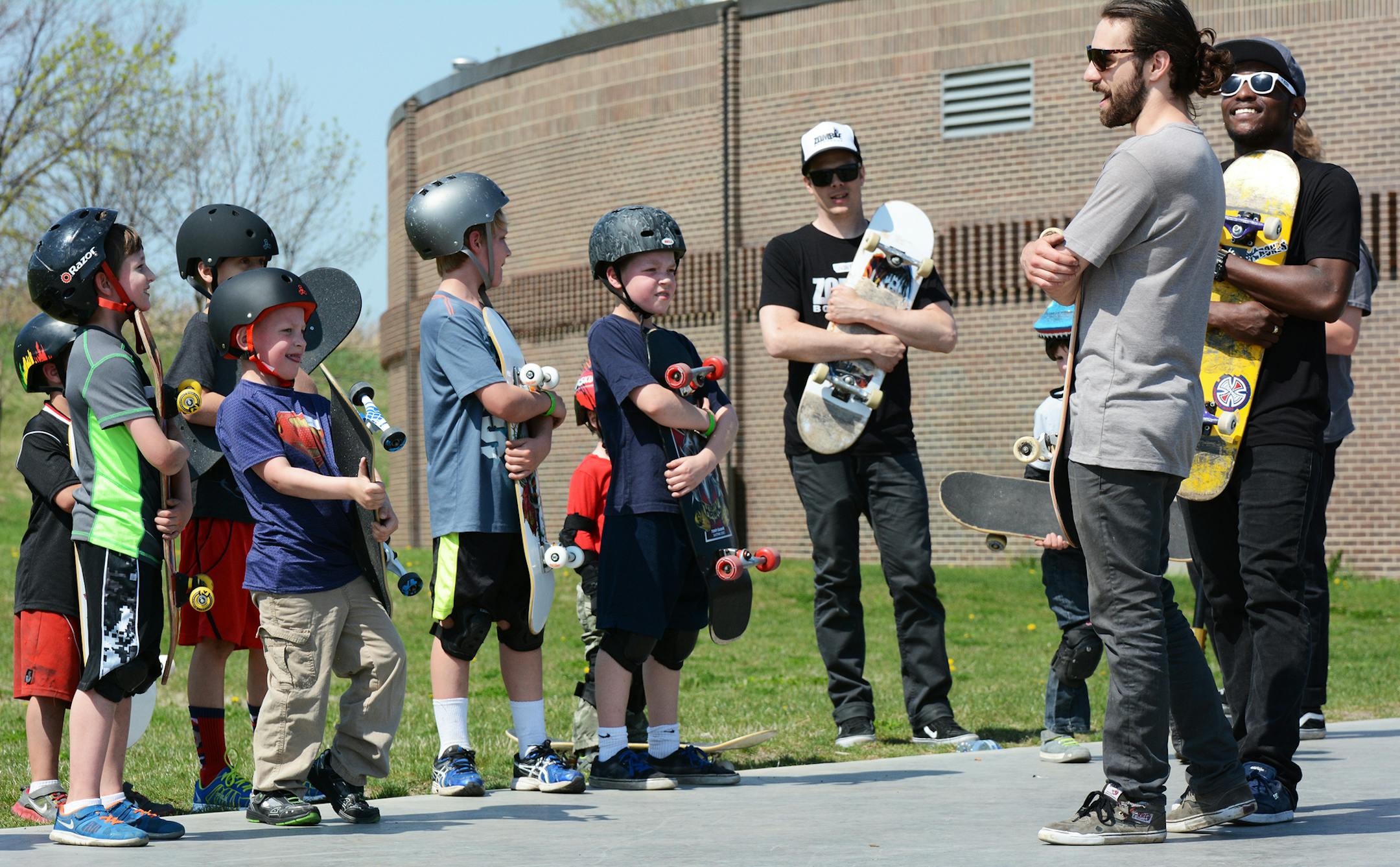 Instructors and students at a beginner's skateboard clinic in Burnsville hugged their boards. Photo by Liz Rolfsmeier, Special to the Star Tribune