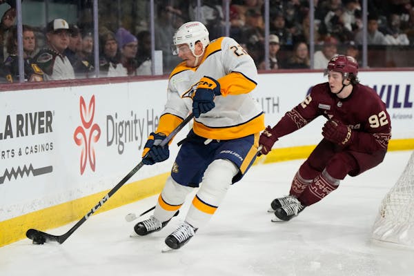 Predators defenseman Tyson Barrie (22) skates away from Coyotes center and former Gophers star Logan Cooley during the third period, but Cooley scored