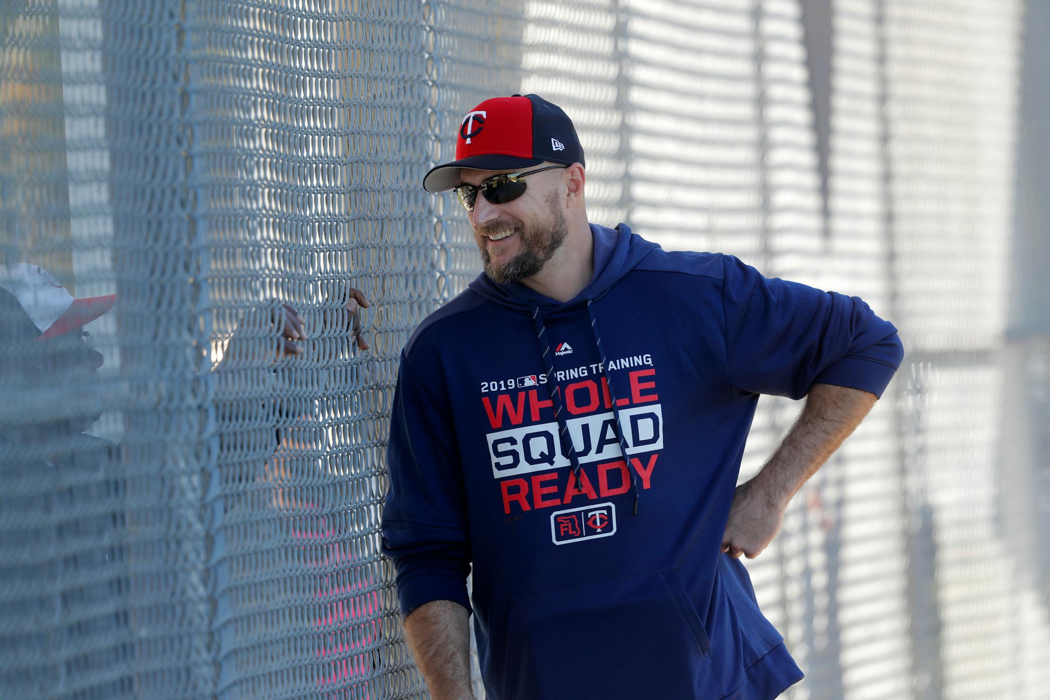 FILE - In this Thursday, Feb. 14, 2019, file photo, Minnesota Twins manager Rocco Baldelli talks through a fence as pitchers and catchers report for their first workout at their spring training baseball facility in Ft. Myers, Fla. The Twins are starting fresh with the youngest manager in the major leagues, a remade infield and a new closer. Starting fresh doesn't have to mean starting over, though, and the Twins have designs on contending for the division title. (AP Photo/Gerald Herbert, File)