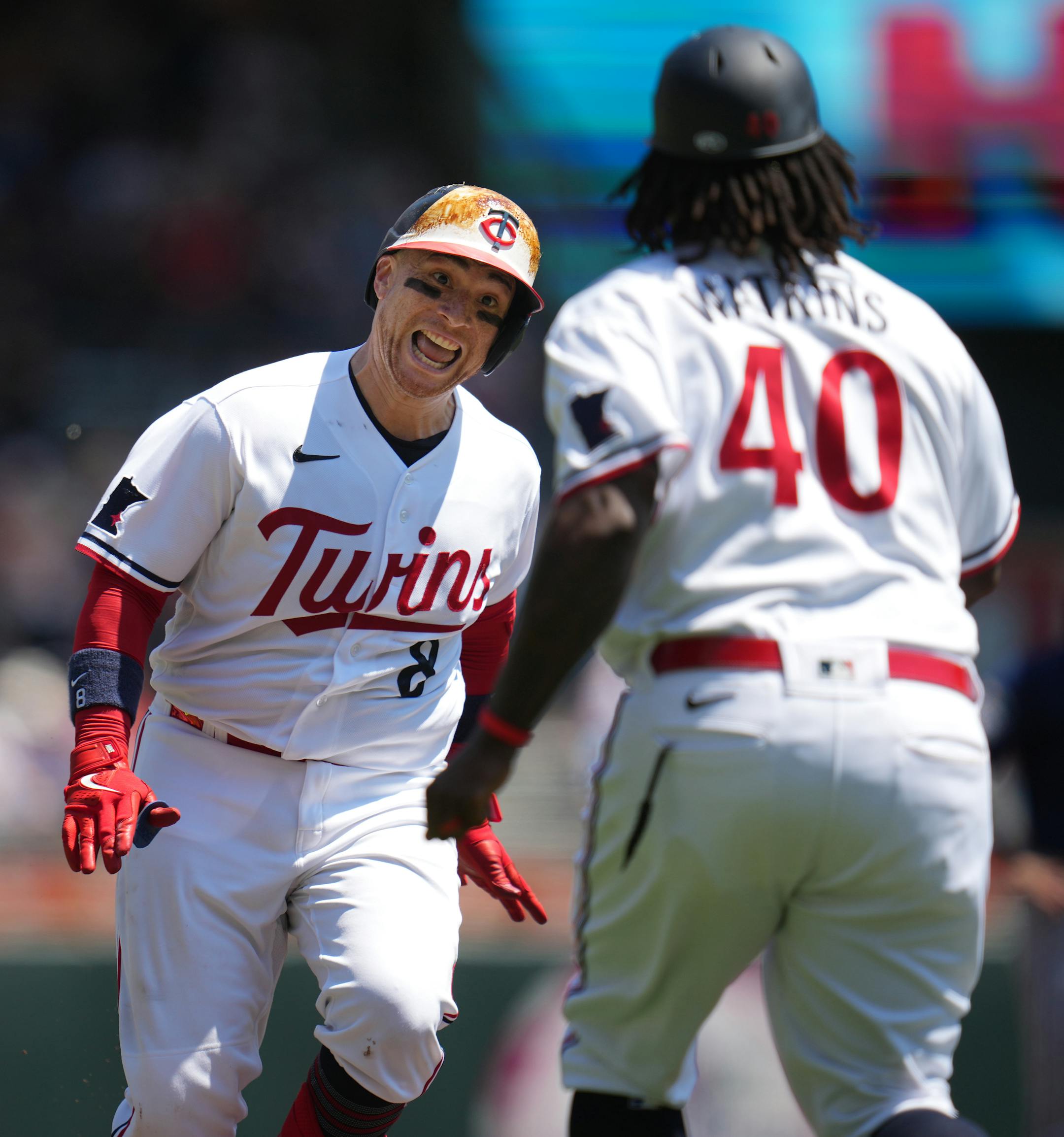 Minnesota Twins catcher Christian Vazquez (8) is congratulated by Minnesota Twins third base coach/outfield coach Tommy Watkins (40) as he rounds the bases in the 3rd inning.
