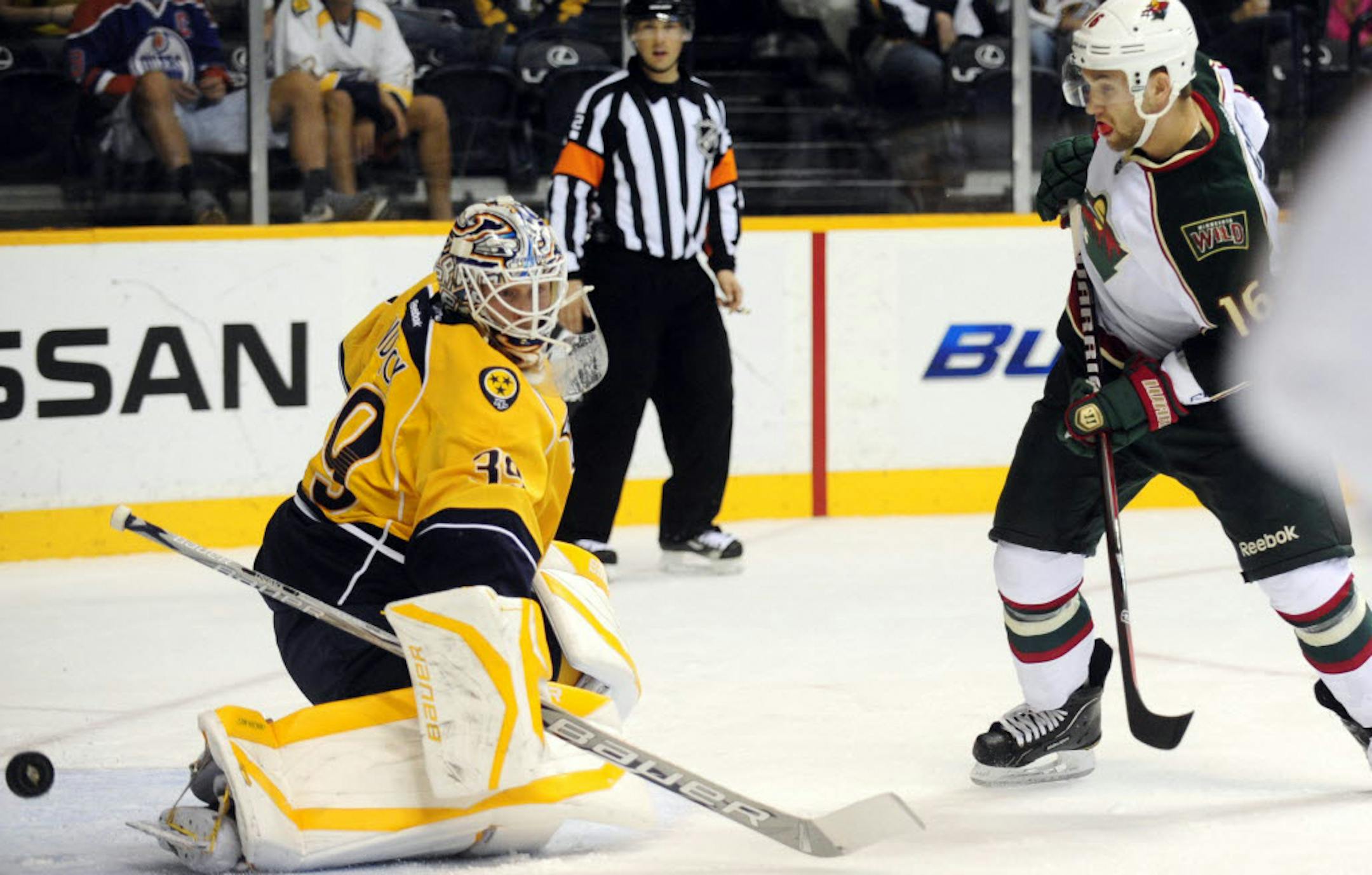 Nashville goalie Anders Lindback deflects the shot of Wild left winger Jason Zucker.