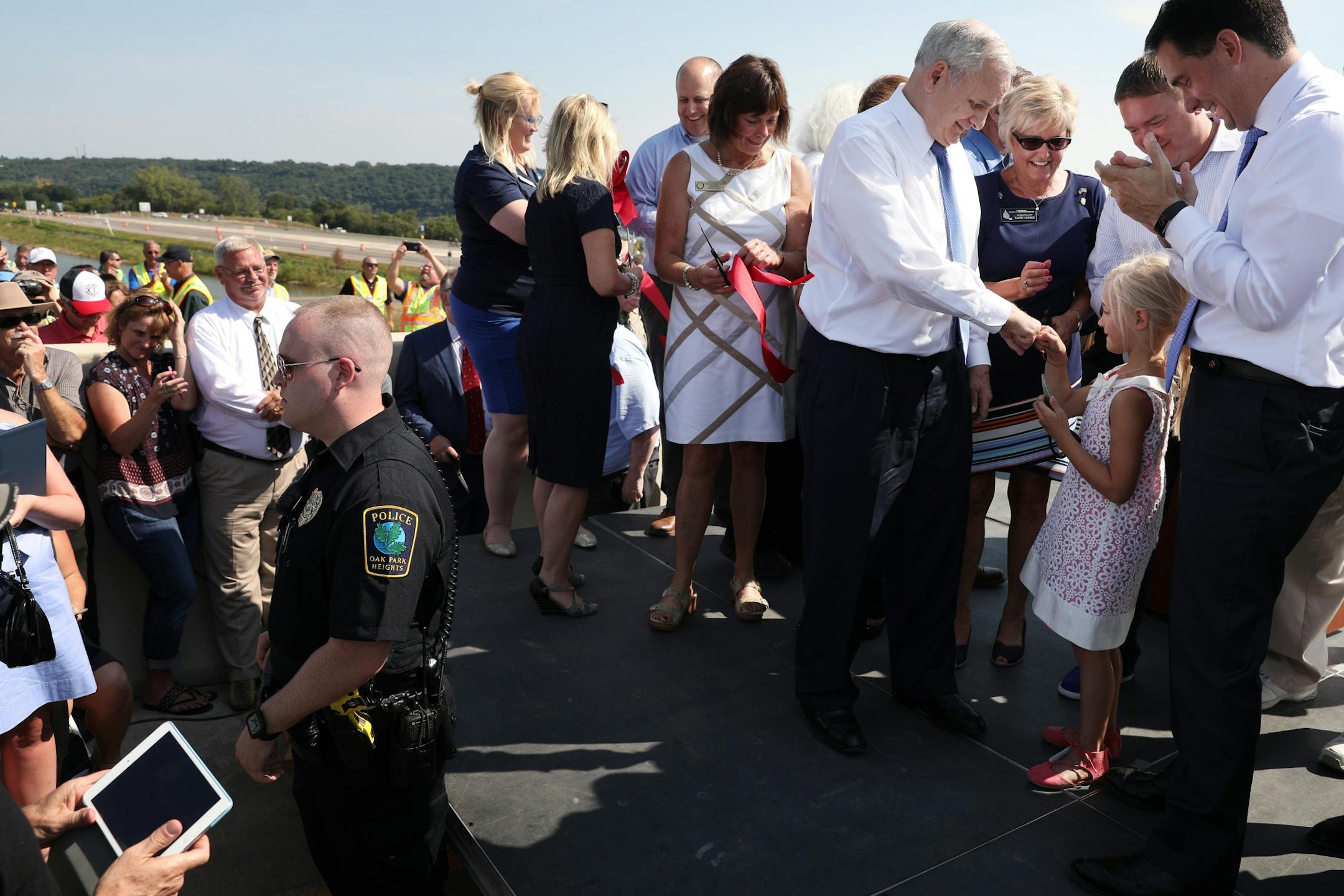 Minnesota Gov. Mark Mark Dayton gave a fist bump to Evie Kozlowski, 7, after she cut the second ribbon.