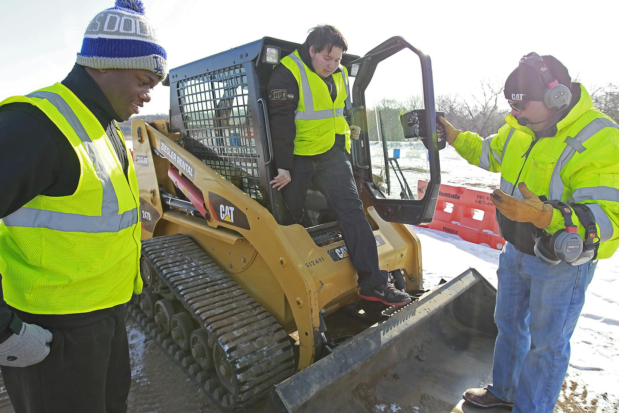 Bloomington senior Torrance Gray, left, and freshman, Buddy Michelson, center took instruction from Extreme Sandbox instructor and owner Randy Stenger, on how to drive a skid steer, Wednesday, February 18, 2015 in Hastings, MN. ] (ELIZABETH FLORES/STAR TRIBUNE) ELIZABETH FLORES • eflores@startribune.com