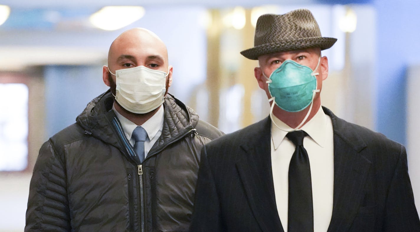 Former Minneapolis police officer J. Alexander Kueng, left, enters the Hennepin County Public Safety Facility in Minneapolis on Monday morning, June 29, 2020, with his attorney, Thomas Plunkett, right, for a hearing. Kueng is one of four officers, who were fired after George Floyd's May 25 death. Derek Chauvin, 44, is charged with second-degree murder and other counts, while Thomas Lane, 37; Kueng, 26; and Tou Thao, 34, are charged with aiding and abetting Chauvin. (Glen Stubbe/Star Tribune via