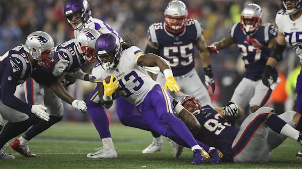 Minnesota Vikings running back Dalvin Cook (33) was brought down by New England Patriots defensive tackle Lawrence Guy (93) while gaining nothing on a