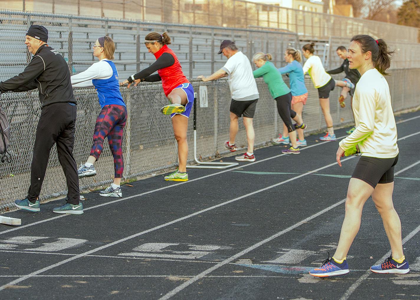 Nicole Cueno, right, coaches athletes during track workout.