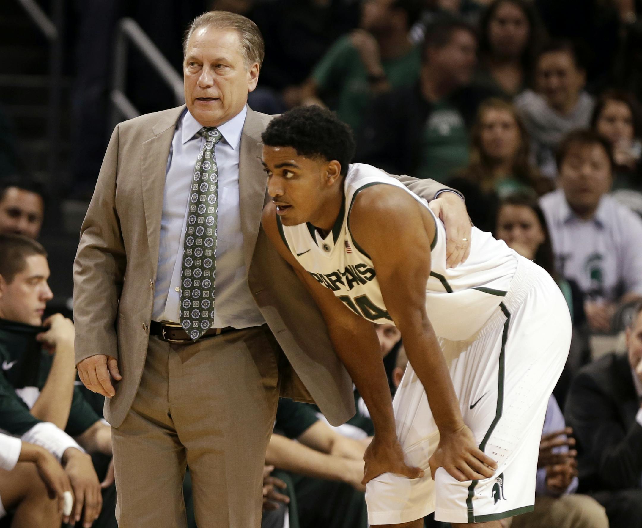 Michigan State head coach Tom Izzo, left, talks to Gary Harris during the first half of a Coaches vs. Cancer NCAA college basketball game against Virginia Tech, Friday, Nov. 22, 2013, in New York. (AP Photo/Frank Franklin II)