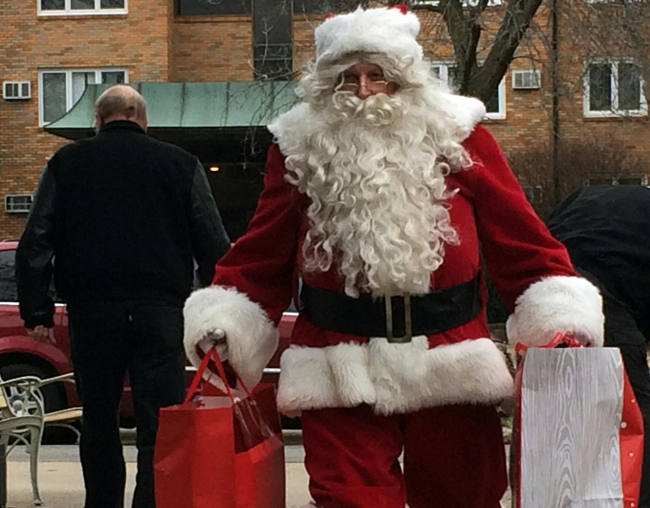 Mark Windschitl, a retired St. Louis Park firefighter, delivers gifts to seniors Thursday at the Golden LivingCenter nursing home in St. Louis Park. Firefighters collected more than 300 gifts for isolated and needy seniors, with assistance from Lunds & Byerlys and Home Instead Senior Care.