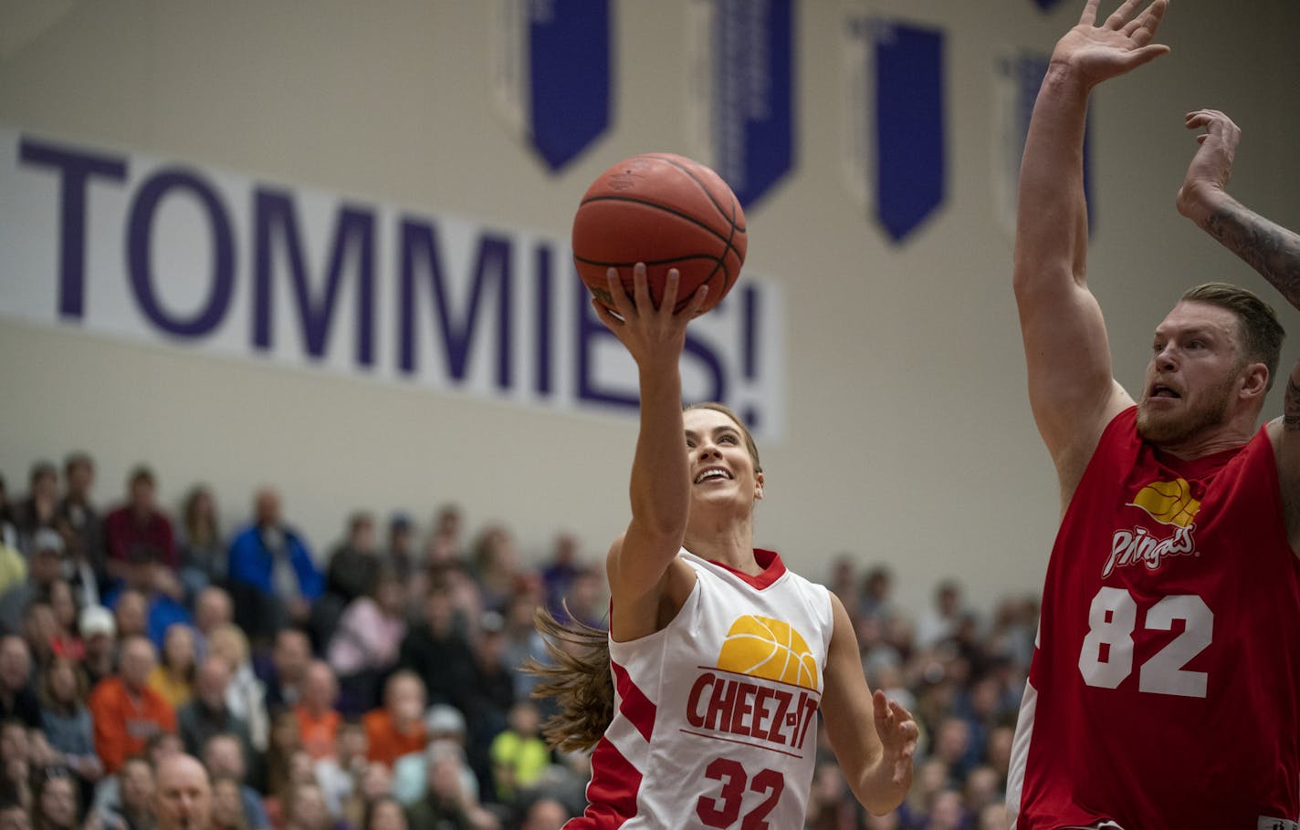 Rachel DeMita put up a shot in front of Kyle Rudolph, who got a hand on it to deflect it. ] JEFF WHEELER &#x2022; jeff.wheeler@startribune.com The Celebrity Crunch Classic was held in Schoenecker Arena on the University of St. Thomas campus in St. Paul Sunday afternoon, April 7, 2019. Vikings tight end Kyle Rudolph was able to show off his considerable basketball skills for his Team Pringles coach, Charles Barkely. Team Pringles prevailed 69-66.