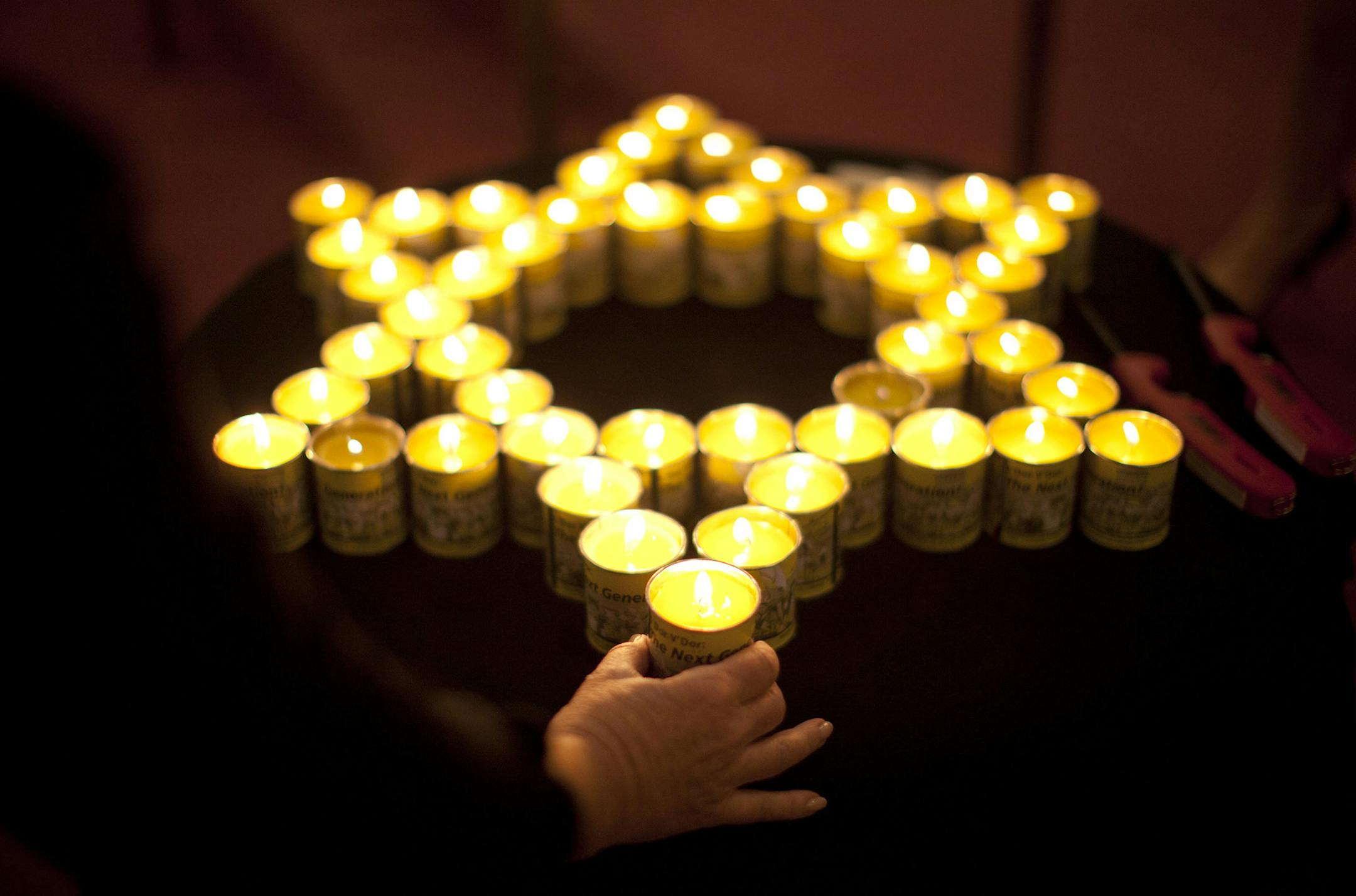 The 2012 Twin Cities Yom HaShoah Commemoration was held Thursday night, April 19, 2012 at Beth Jacob Congregation in Mendota Heights, Minn. Rabbi Morris Allen told the hundreds who attended, "We gather here tonight to remember our brothers and sisters who perished in the Shoa, whose hearts were stilled and whose stories were ended. And to give witness that we will not forget." In keeping with tradition, Holocaust survivors lit candles in memory of those who perished in the Holocaust. A volunteer