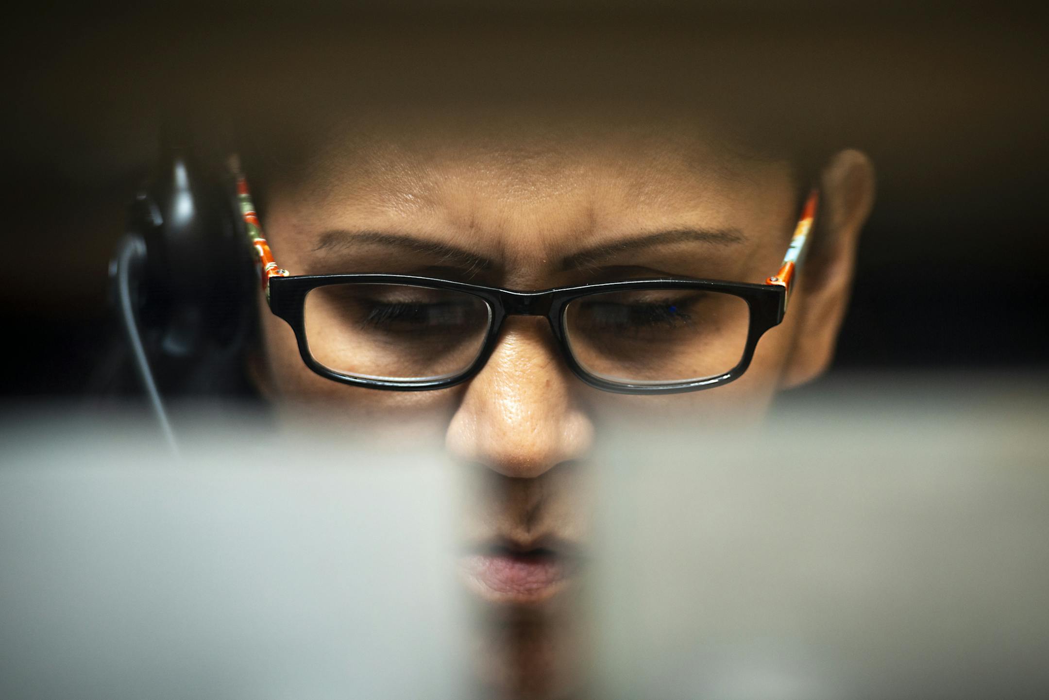 In this Thursday, July 11, 2019, photo Tamara Reuben, 50, answers calls during her shift at the Idaho Suicide Prevention Hotline in Boise, Idaho. (Jake King/The Denton Record-Chronicle via AP)