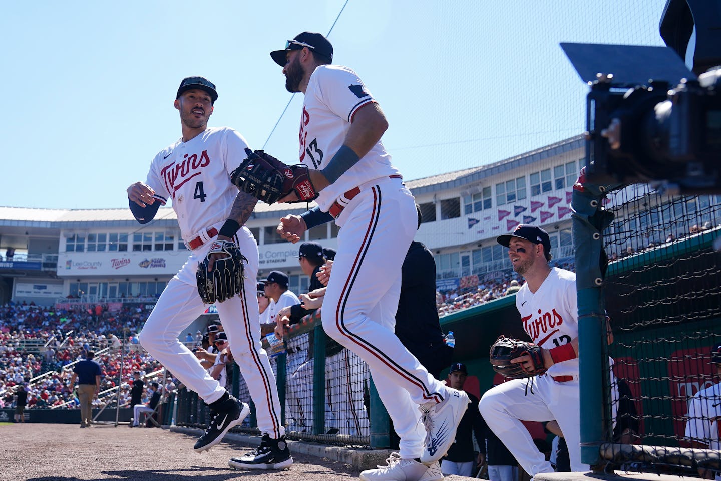 Minnesota Twins shortstop Carlos Correa (4) and Minnesota Twins left fielder Joey Gallo (13) take the field before a spring training baseball game against the Philadelphia Phillies, Wednesday, March 1, 2023, in Fort Myers, Fla. (AP Photo/Brynn Anderson)