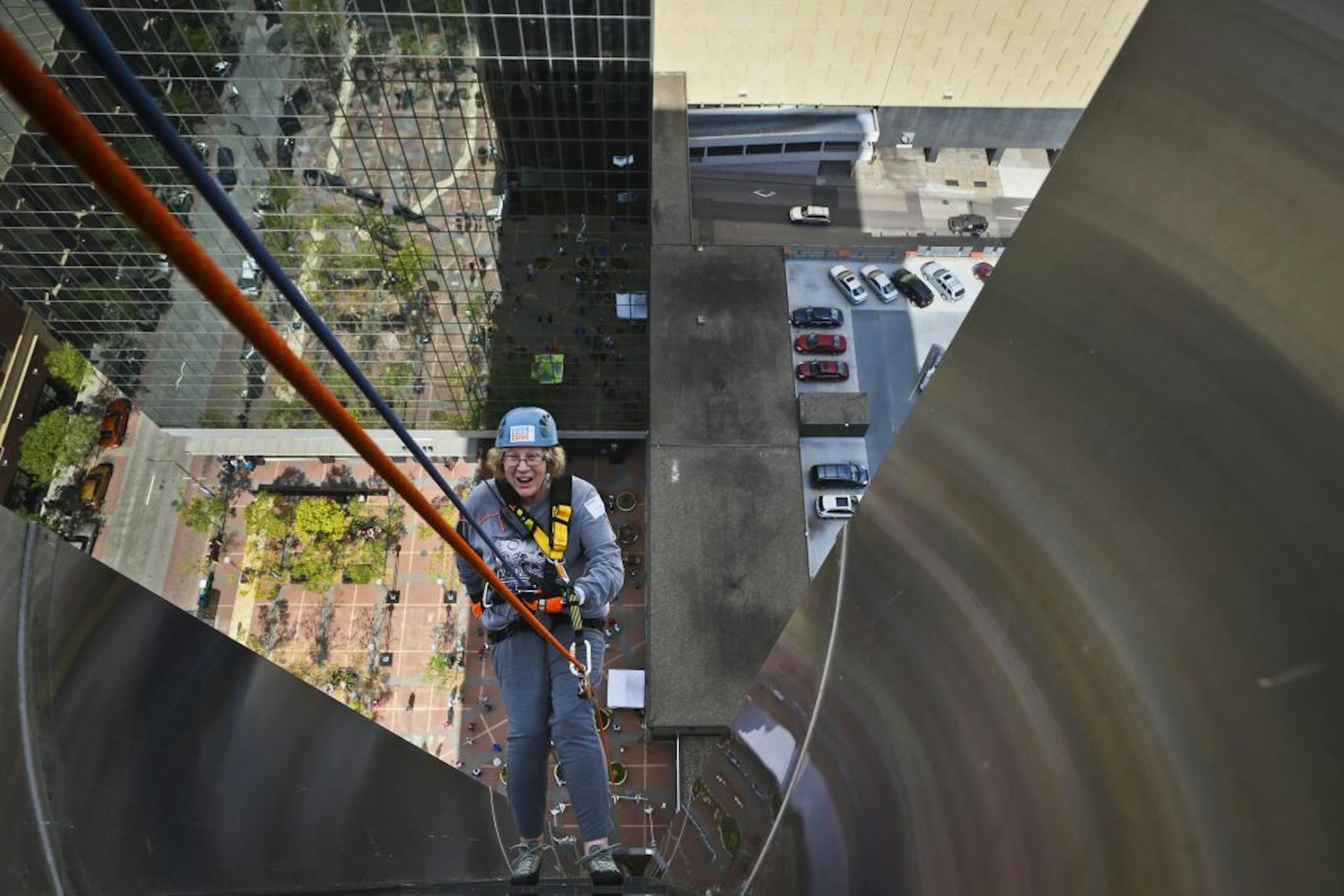 Susan Johnson rappelled down the side of the Ecolab building to raise money and to honor her son.