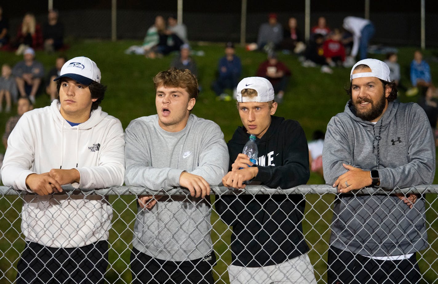 Lakeville South players Alex Vazquez, Owen McCloud, Camden Dean and head coach Ben Burk scouted the Shakopee football team while they played Eden Prairie on October 8, 2021. ]