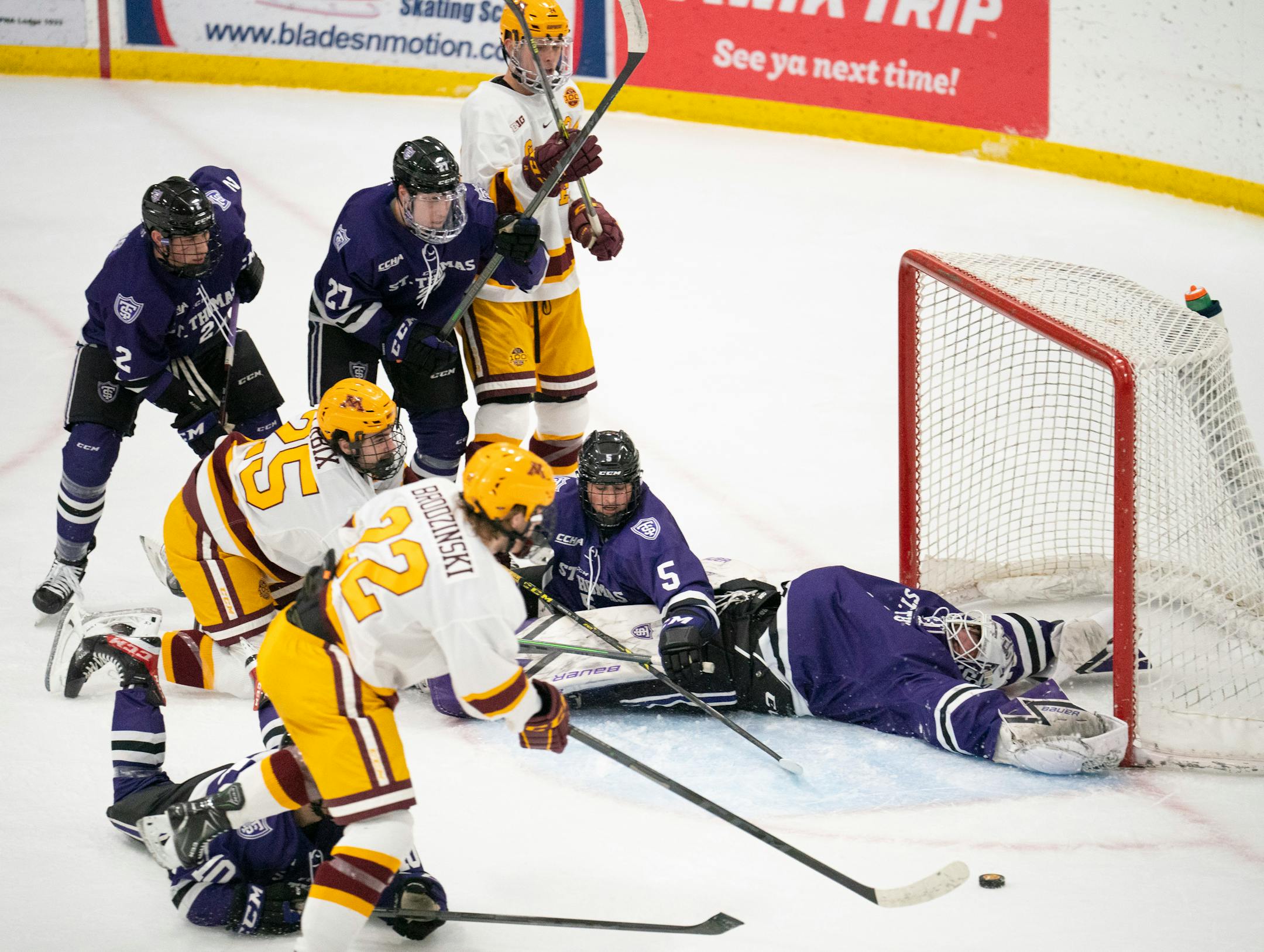 Gophers forward Bryce Brodzinski (22) tried to get to the loose puck with Tommies goaltender Jacob Berger (31) sprawled in the crease in the first period Sunday afternoon, Jan. 2, 2022 at Doug Woog Arena in South St. Paul.
