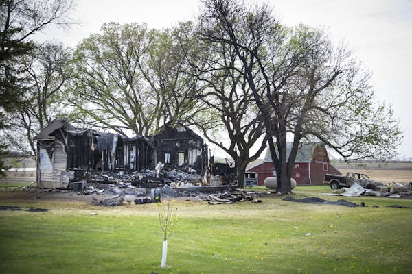 The burned farmhouse at the scene of a double homicide on Monday, May 4, 2015,in Balaton, Minn.