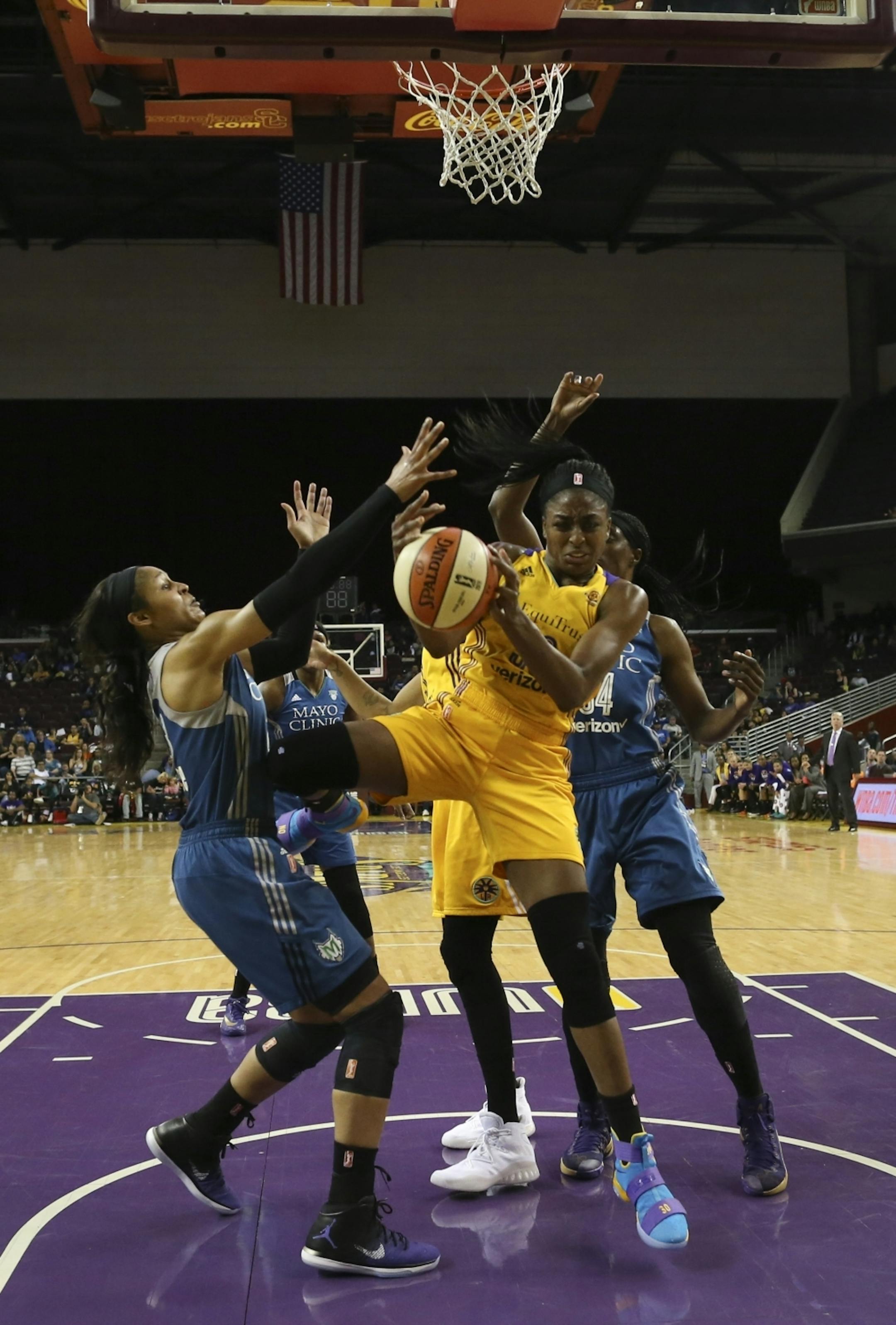 Los Angeles Sparks forward Nneka Ogwumike (30) grabbed a defensive rebound ahead of Lynx forward Maya Moore (23) and center Sylvia Fowles (34) in the first half.