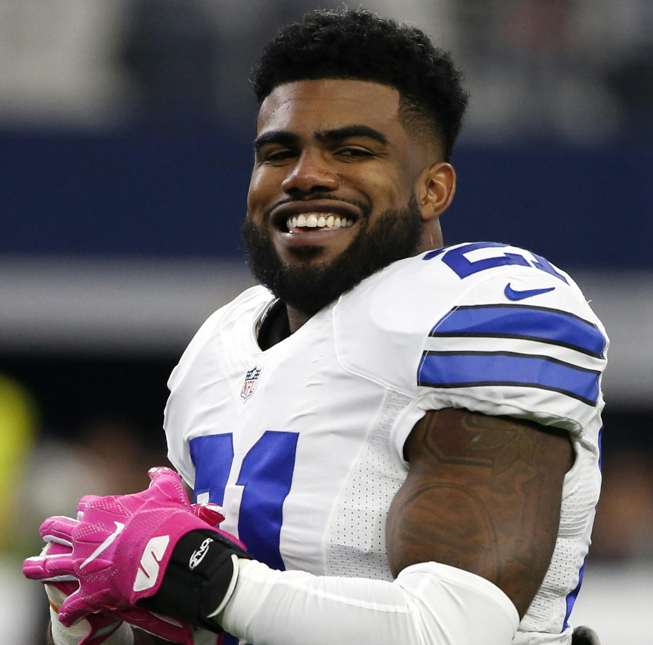 Dallas Cowboys' Ezekiel Elliott smiles as he talks with teammates during warm ups before an NFL football game against the Cincinnati Bengals on Sunday, Oct. 9, 2016, in Arlington, Texas. (AP Photo/Ron Jenkins)