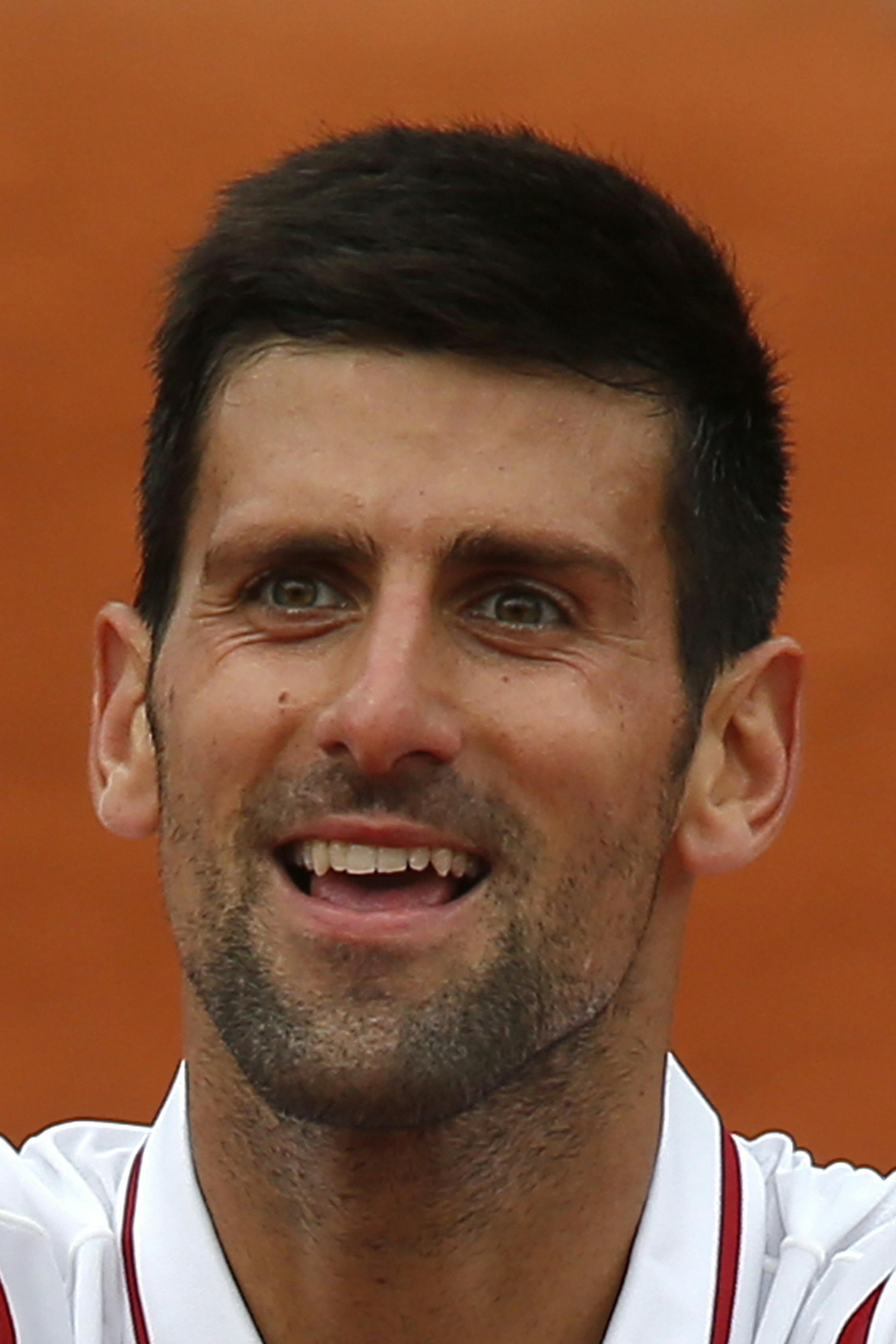 Serbia's Novak Djokovic cheers the audience after defeating Belgiumís Steve Darcis during their second round match of the French Open tennis tournament at the Roland Garros stadium, Thursday, May 26, 2016 in Paris. Djokovic won 7-5, 6-3, 6-4. (AP Photo/Michel Euler)