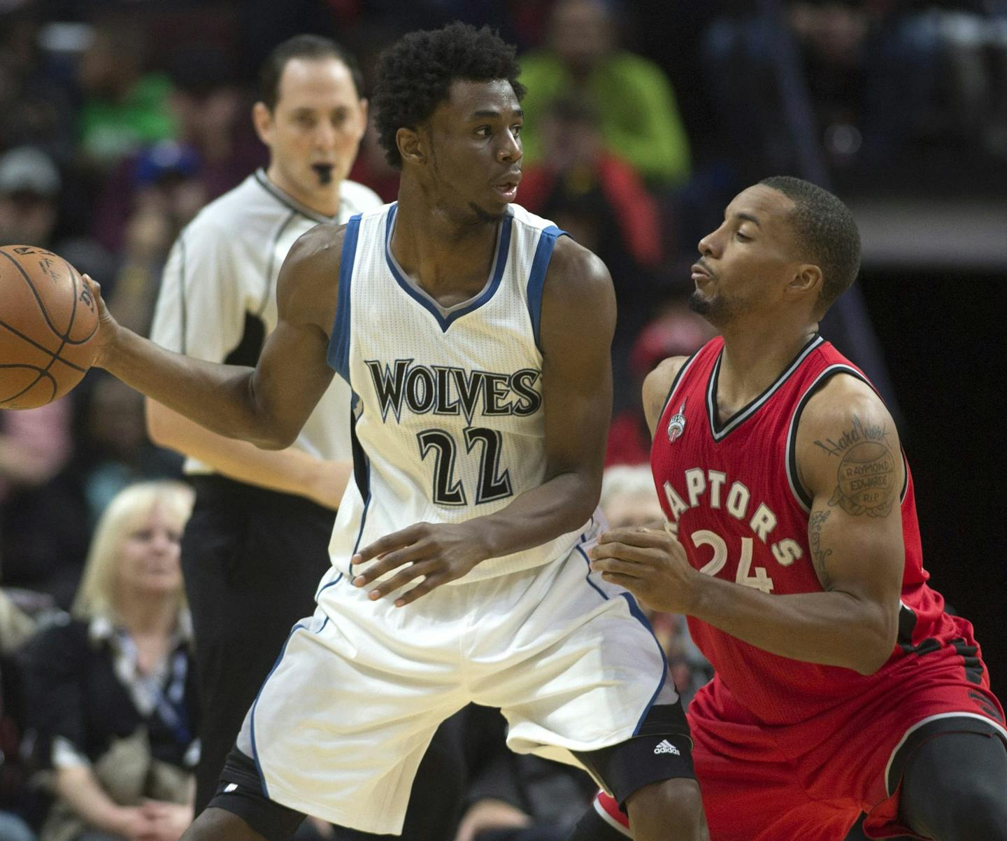 Minnesota Timberwolves forward Andrew Wiggins drives to the net past Toronto Raptors guard Norman Powell during the second half of an NBA preseason basketball game, Wednesday, Oct. 14, 2015 in Ottawa, Ontario. The Timberwolves defeated the Raptors 89-87. (Adrian Wyld/The Canadian Press via AP) MANDATORY CREDIT