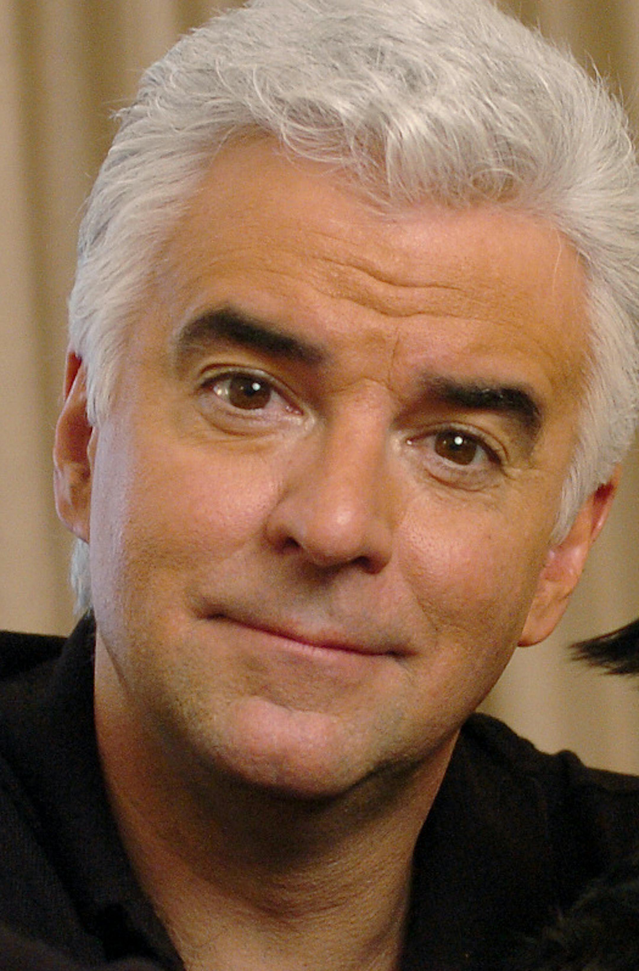 Actor John O'Hurley relaxes at the Phillips Club in Manhattan, New York, January 19, 2006, with Betty, a dog that he rescued. The 51-year-old actor, who is best known for his role as kooky catalog king J. Peterman on the television comedy "Seinfeld," is currently starring as sexy shyster Billy Flynn in the Broadway production of "Chicago." (Susan Watts/New York Daily News/KRT)