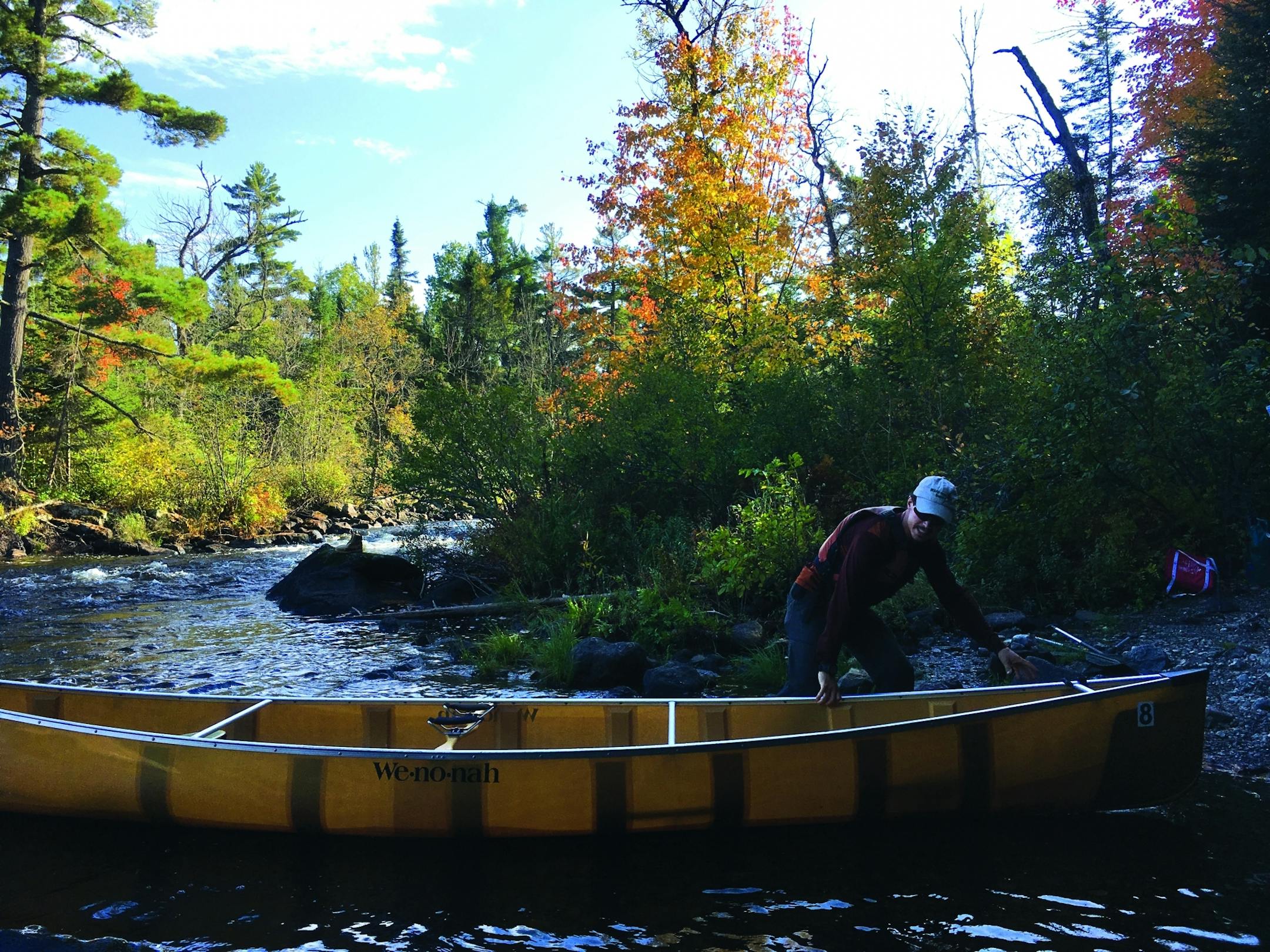After a short portage, guide Devan Landseidel slid the canoe into Fall Lake. Photo by Jenna Ross * jenna.ross@startribune.com