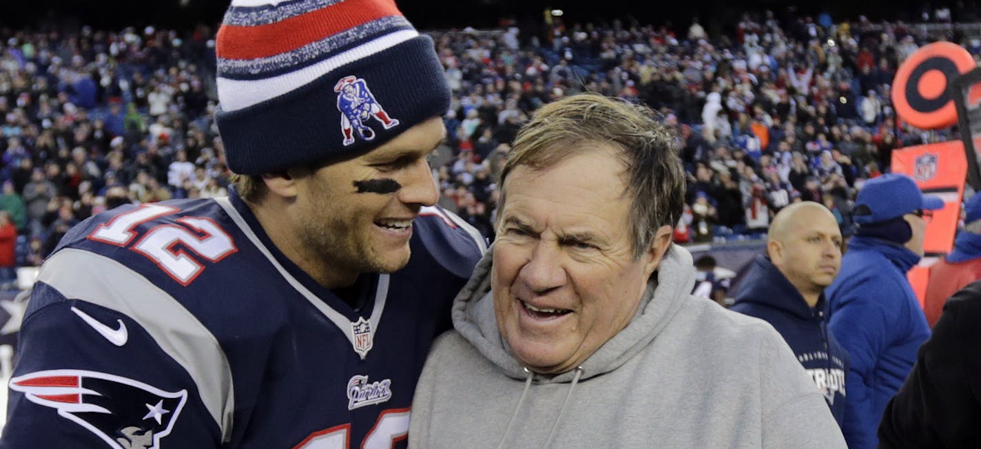 New England Patriots quarterback Tom Brady, left, celebrates with head coach Bill Belichick after defeating the Miami Dolphins 41-13 in an NFL football game Sunday, Dec. 14, 2014, in Foxborough, Mass. (AP Photo/Charles Krupa)