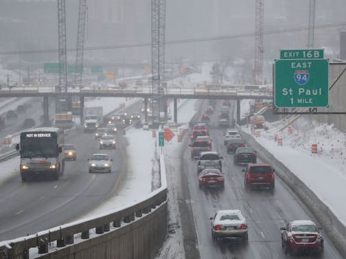 Snow this morning slowed traffic near the I-35W and I-94 interchange, seen from the 24th Street foot bridge Tuesday, April 3, 2018, in Minneapolis, MN.