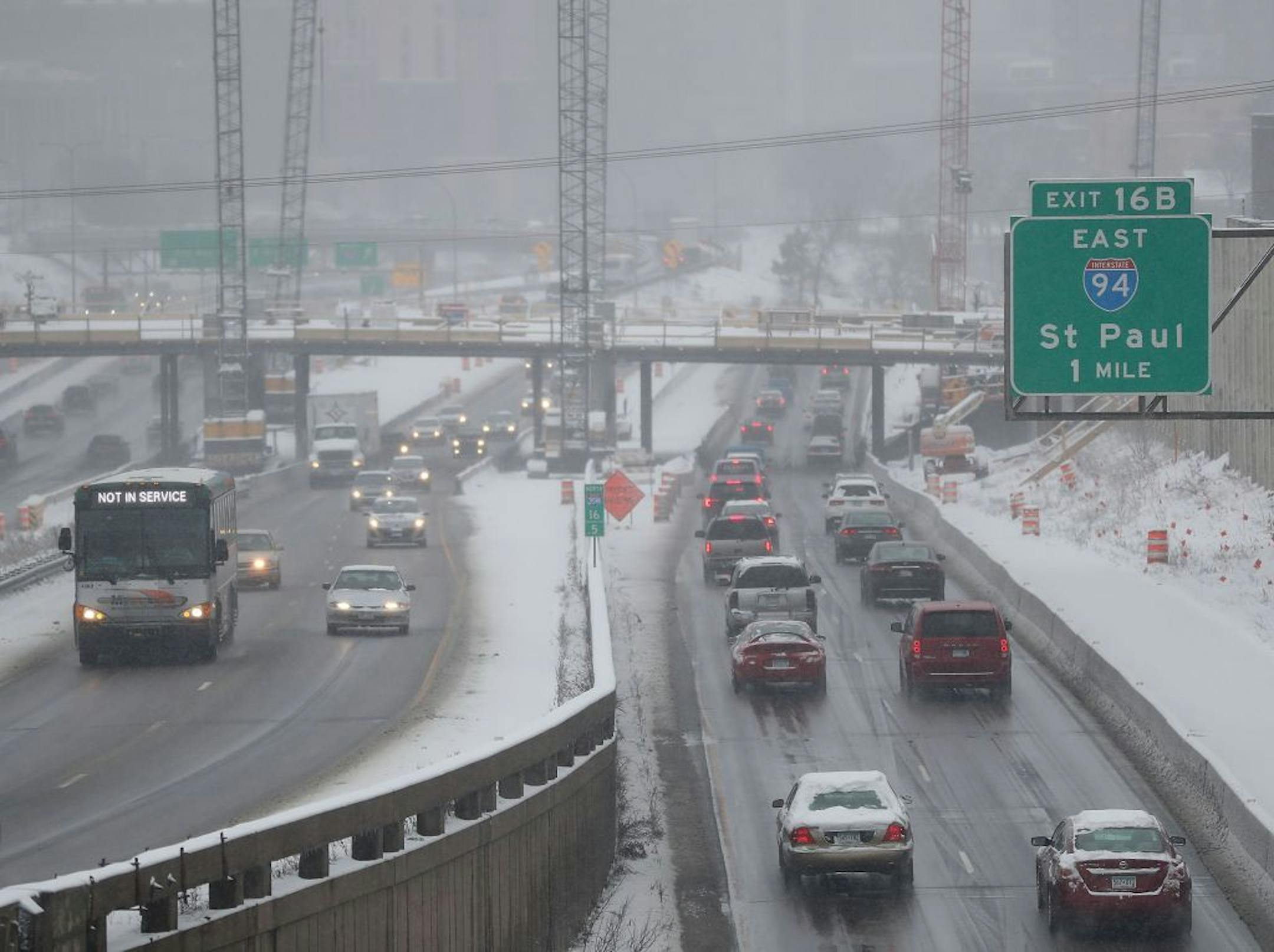 Snow this morning slowed traffic near the I-35W and I-94 interchange, seen from the 24th Street foot bridge Tuesday, April 3, 2018, in Minneapolis, MN.
