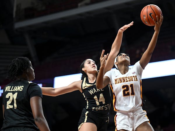 Gophers guard Mi’Cole Cayton (21) scored a basket against Wake Forest’s Niyah Becker (14) in Wednesday’s game at Williams Arena. The Gophers hos