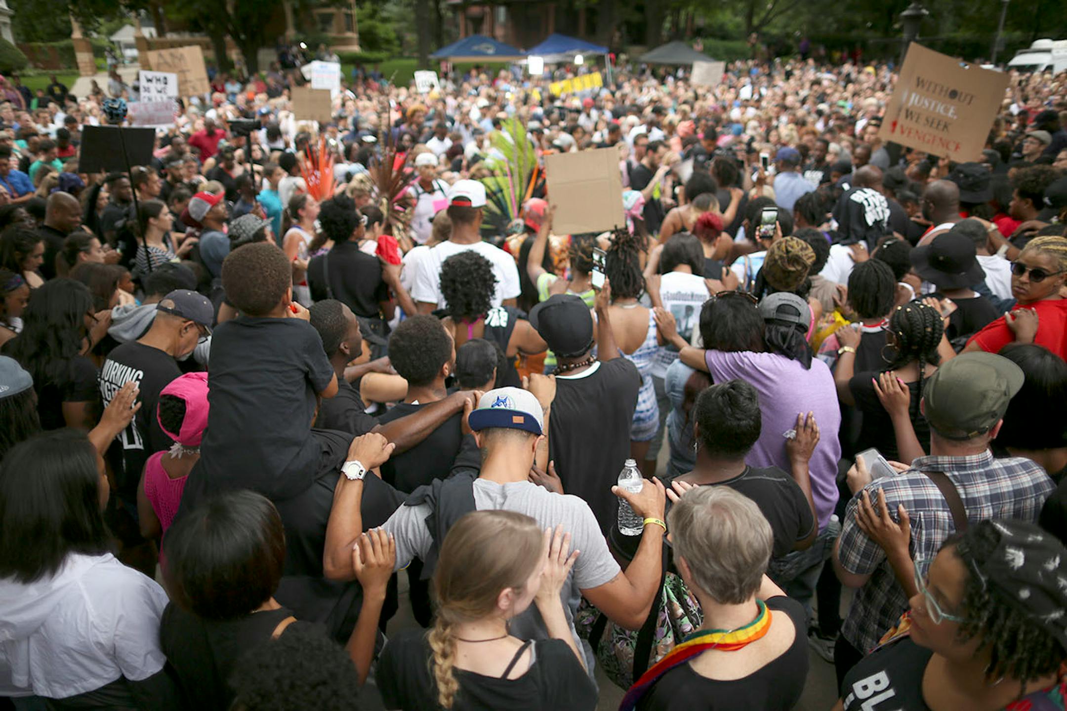 After marchers arrived at the Governor's Residence, they were asked to place a hand on the person standing next to them during a moment of silence for Philando Castile.