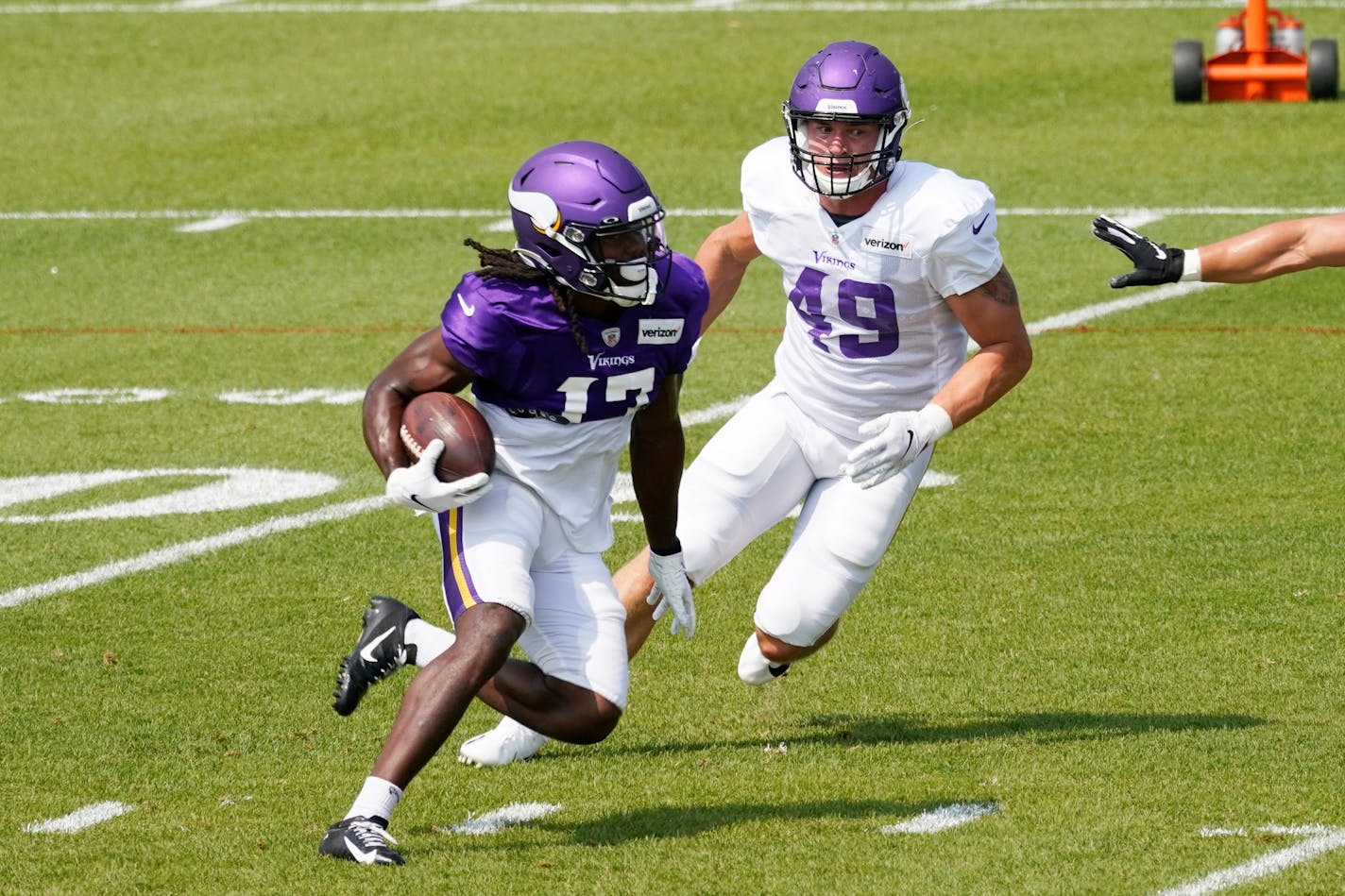 Vikings linebacker Jordan Fehr (49) tried to chase down wide receiver K.J. Osborn during the team's training camp practice Monday. Eight players who missed Sunday's practice because of false positive COVID-19 test, the result of a lab error, were back on the field Monday