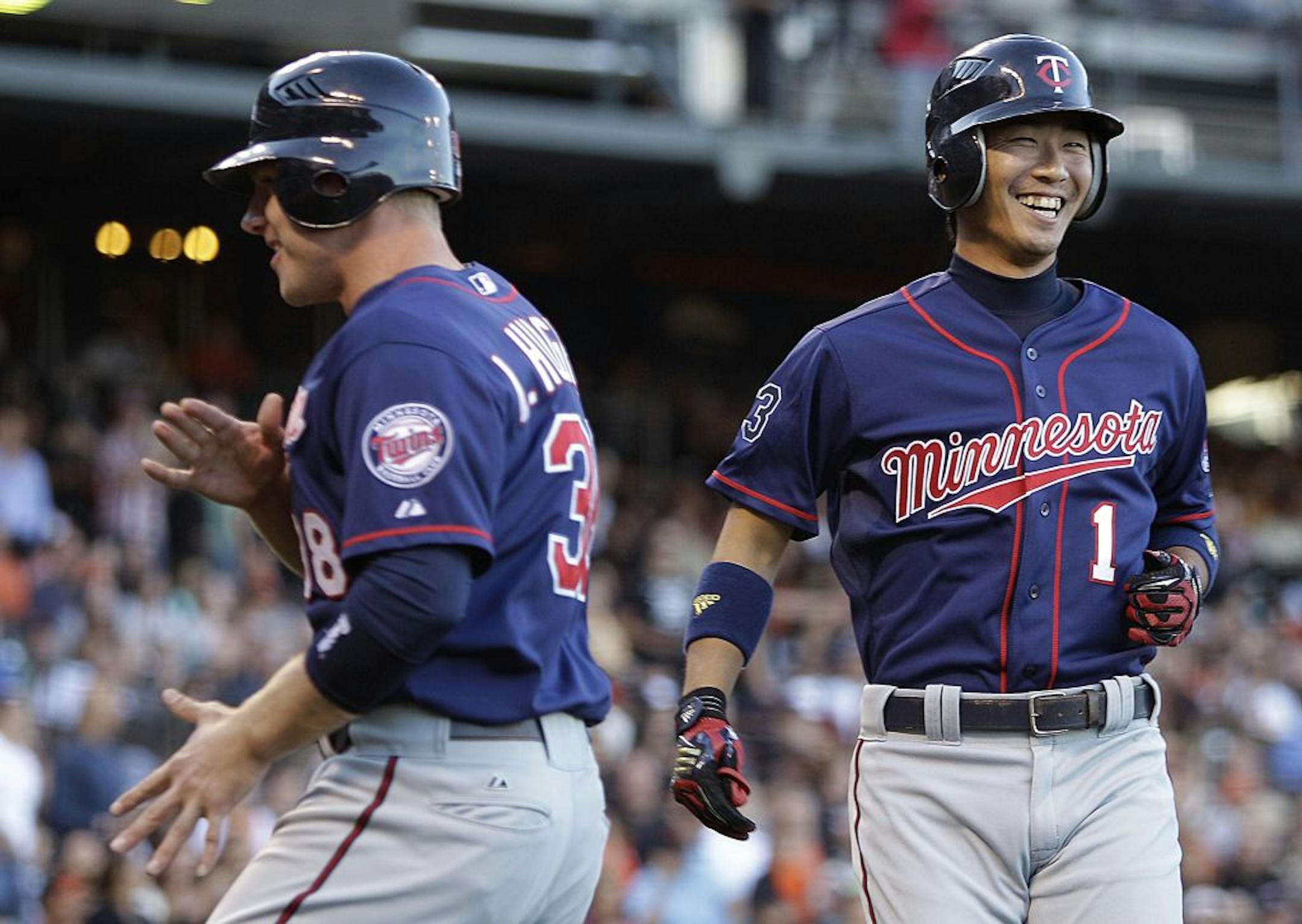 Minnesota's Luke Hughes, left, and Tsuyoshi Nishioka celebrated after scoring against the Giants during the first inning Tuesday.