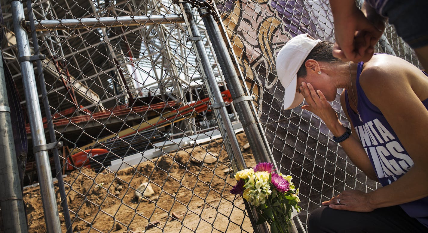 At US Bank Stadium, one worker was killed and another injured in a construction site accident earlier this morning. Angela Strong and daughter Kyra,11, of St. Paul brought a bouquet of flowers and said prayers for the construction workers. "We forget how much danger is involved (in construction), " said Angela.] Richard Tsong-Taatarii/rtsong-taatarii@startribune.com