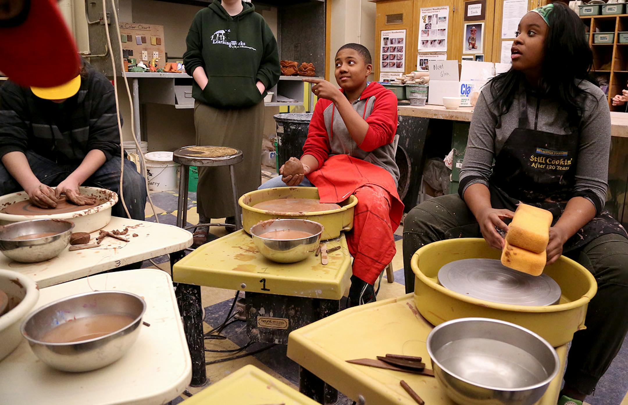 Edison High sophomore Charles Little, center, lobbies for more time from his teacher to throw a bowl for the Empty Bowls fundraiser near the end of ceramics class at Edison High School Thursday, April 13, 2017, in Minneapolis, MN. Looking on is Taseyana Coleman, right, a 9th grader.