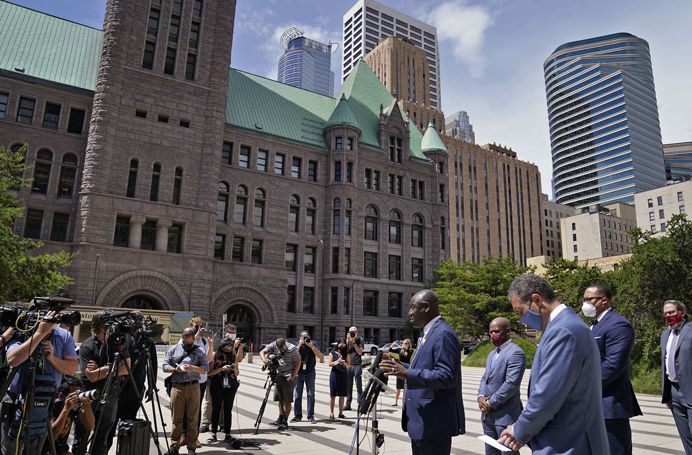 Attorney Ben Crump, who represents George Floyd's family, announced in a press conference that the family of Floyd is suing the city of Minneapolis and the four officers involved in his death, citing a failure in proper police training and a racist departmental culture that led to a "reckless disregard" of Floyd's civil rights Wednesday outside the US Federal Courthouse in Minneapolis. Here, Crump, at podium, with members of his legal team that represent the Floyd family.] DAVID JOLES • david.jo