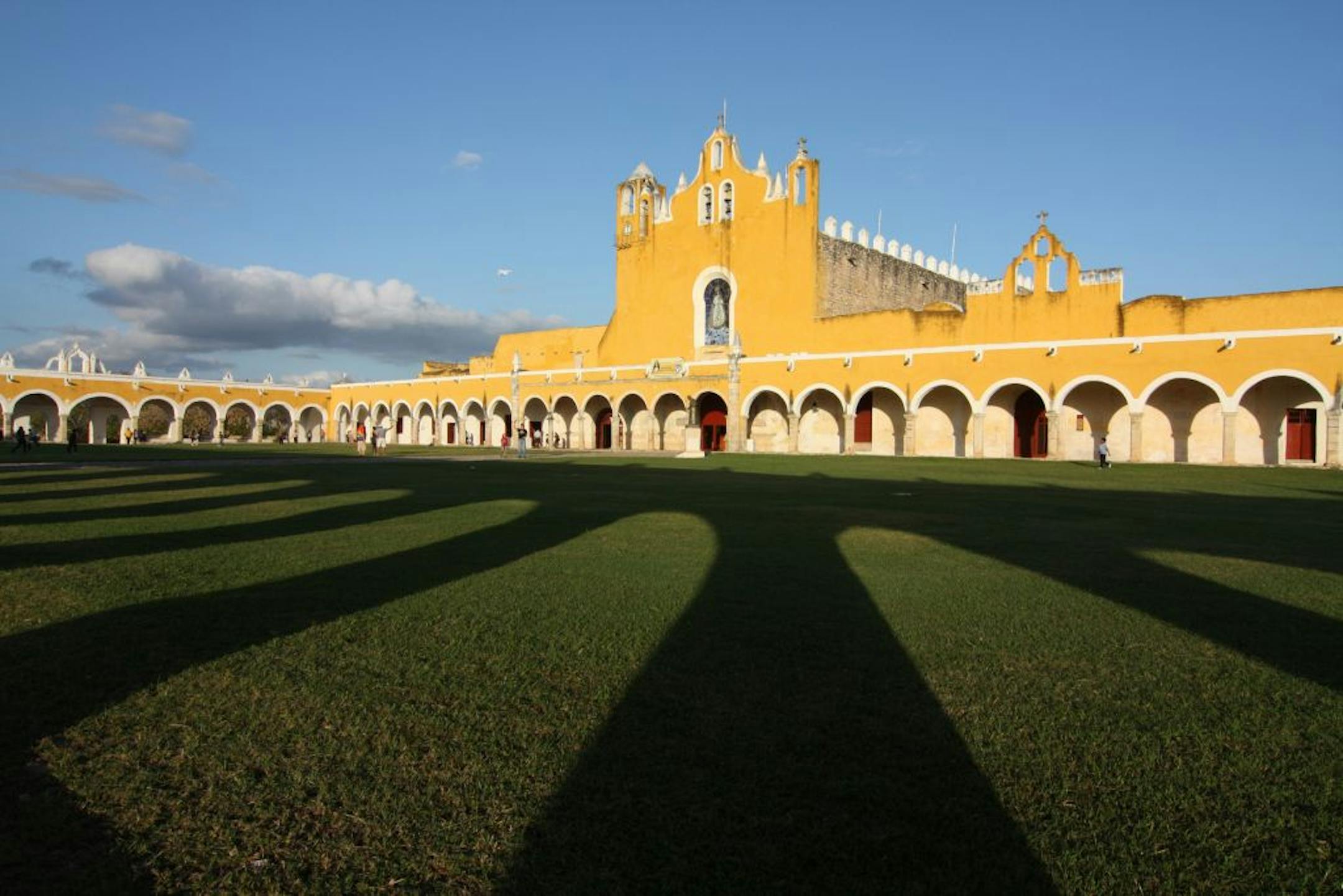 Shadows fell on the sprawling lawn of the Convento de San Antonio de Padua. It sits atop a former Mayan temple in the center of Izamal, a city with buildings bathed in yellow paint.