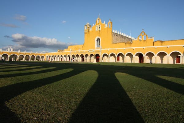 Shadows fell on the sprawling lawn of the Convento de San Antonio de Padua. It sits atop a former Mayan temple in the center of Izamal, a city with bu